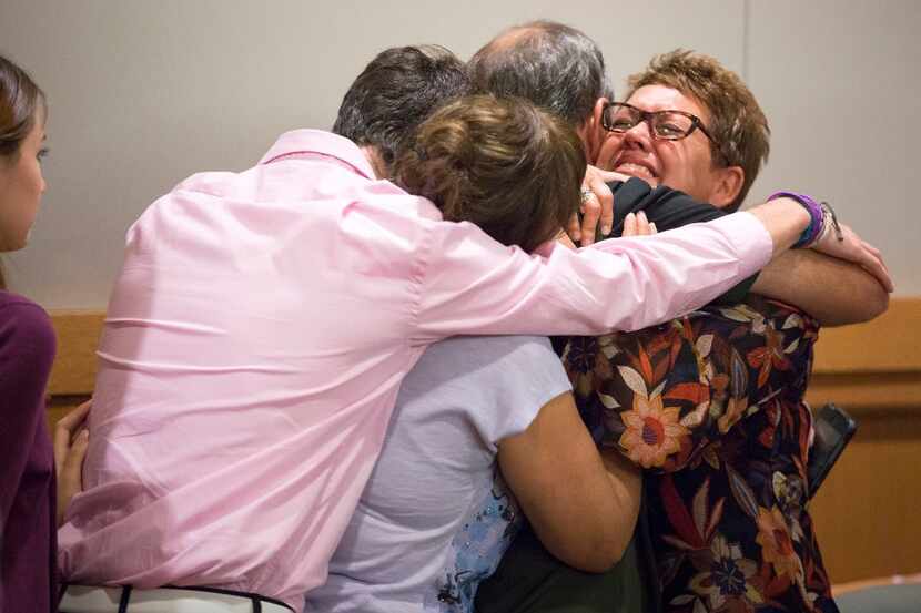 Christina Morris' mother Jonni McElroy (facing) hugs family members after a guilty verdict...