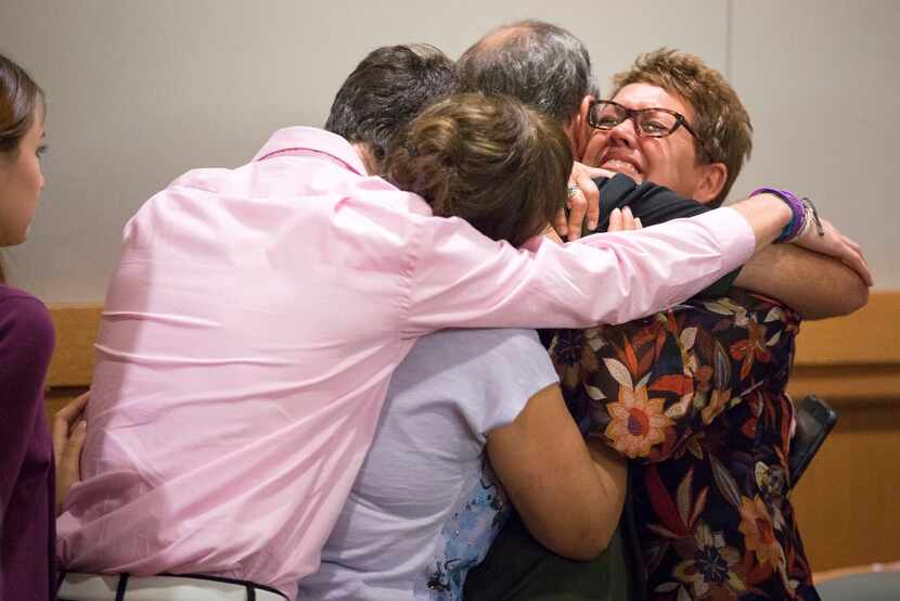 Christina Morris' mother Jonni McElroy hugs family members after a guilty verdict in the...
