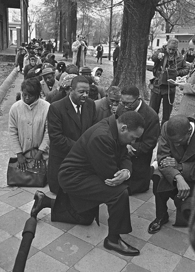  Dr. Martin Luther King Jr., center, leads a group of civil rights workers and Selma black...