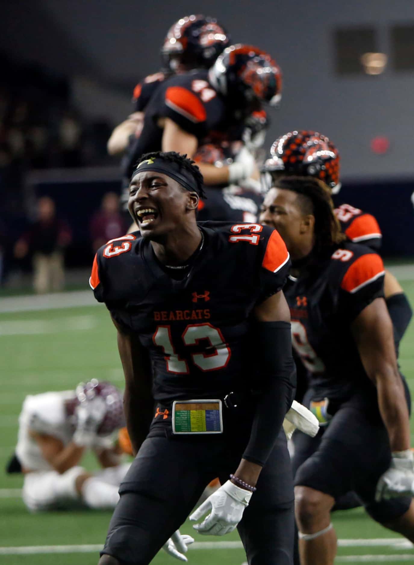 Aledo Bearcats players, including Money Parks (13) celebrate their 43-36 overtime victory...
