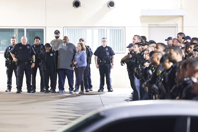 Family members of the deceased Dallas police officer wait outside of the Dallas County...