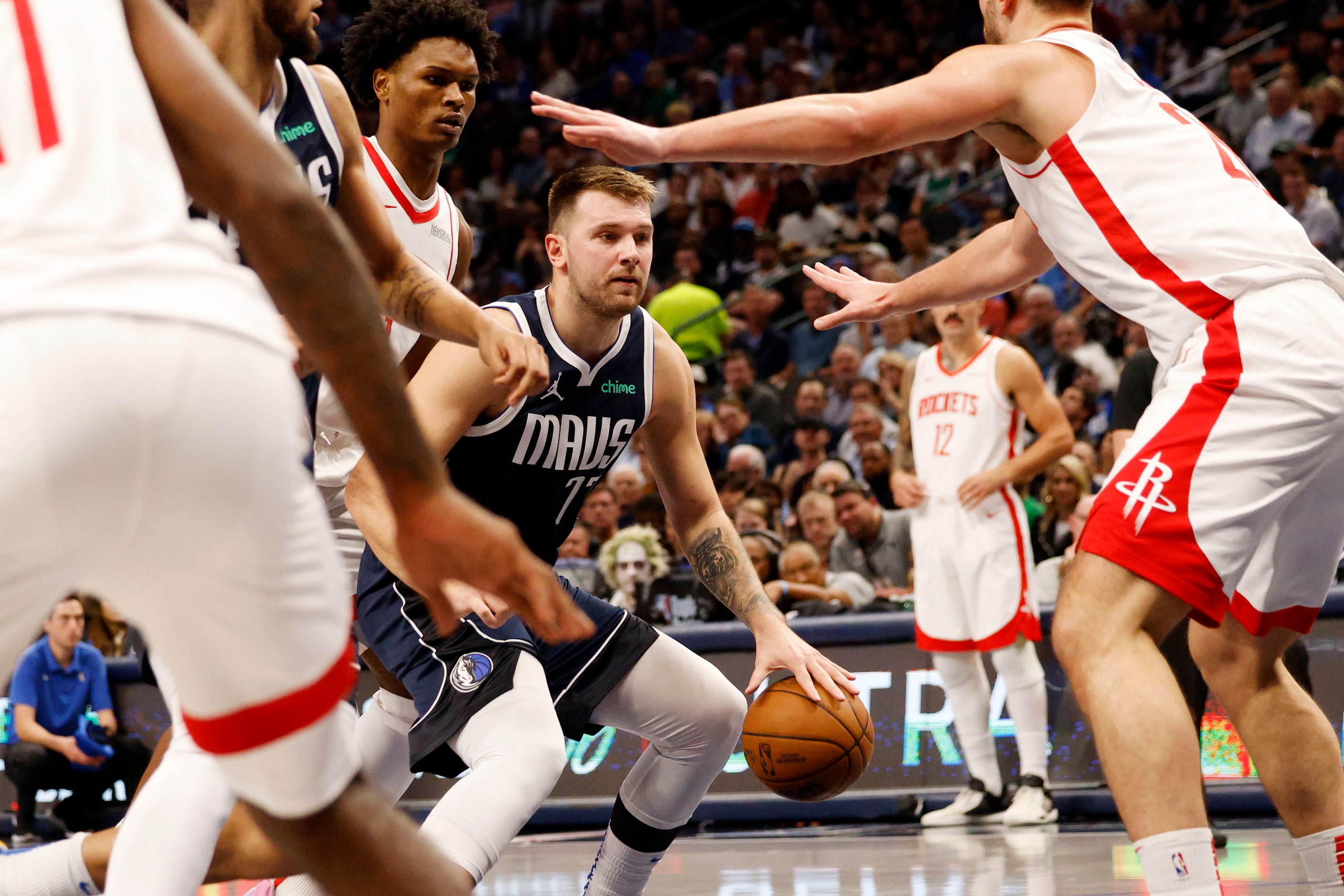 Dallas Mavericks guard Luka Doncic (77) tries to drive past Houston Rockets players during...