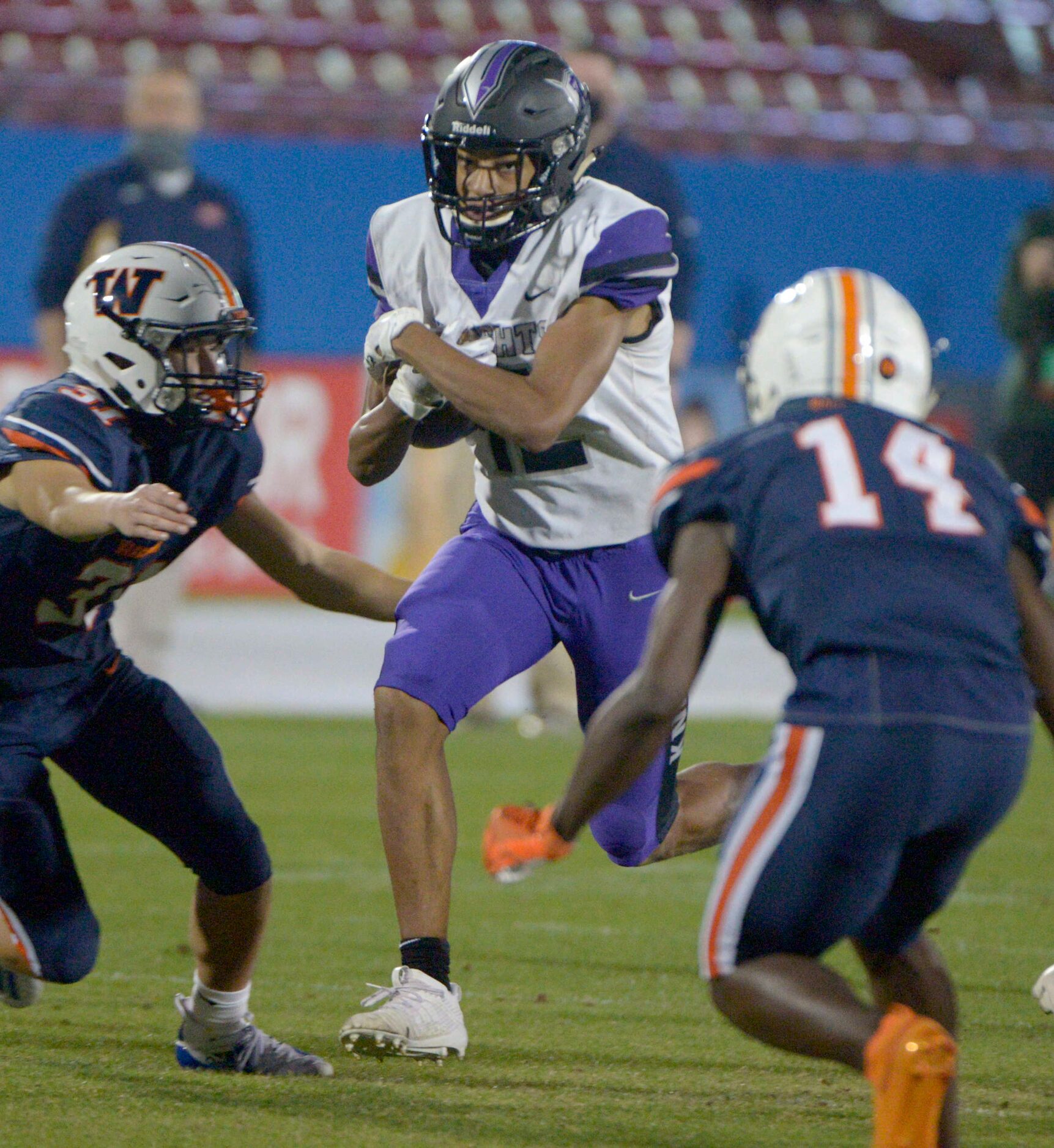 Frisco Independence Reggie Bush (12) runs upfield between Wakeland’s Andrew Cox (31) and...