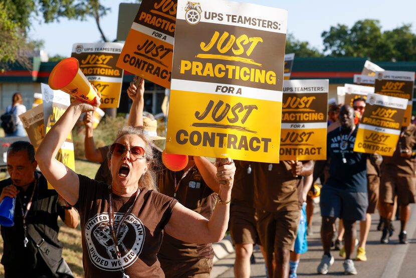 Charlotte Suter, (front) a UPS employee for seven years, alongside other employees, take...