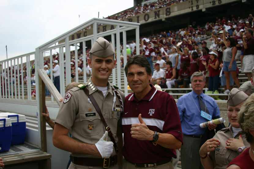Then-Gov. Rick Perry poses with John Huffman at a Texas A&M football game in 2004.