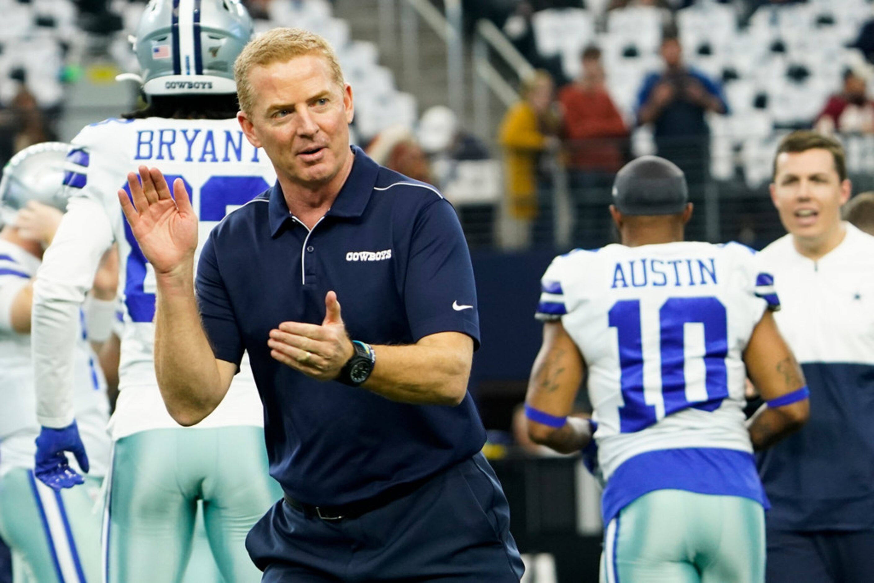 Dallas Cowboys head coach Jason Garrett encourages his team as they warm up before an NFL...