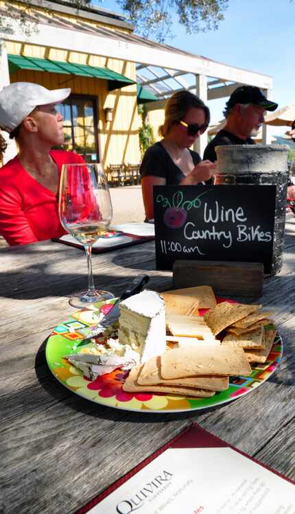 Bikers enjoy a tasting at Quivira Vineyards, known for its biodynamic farming practices. 