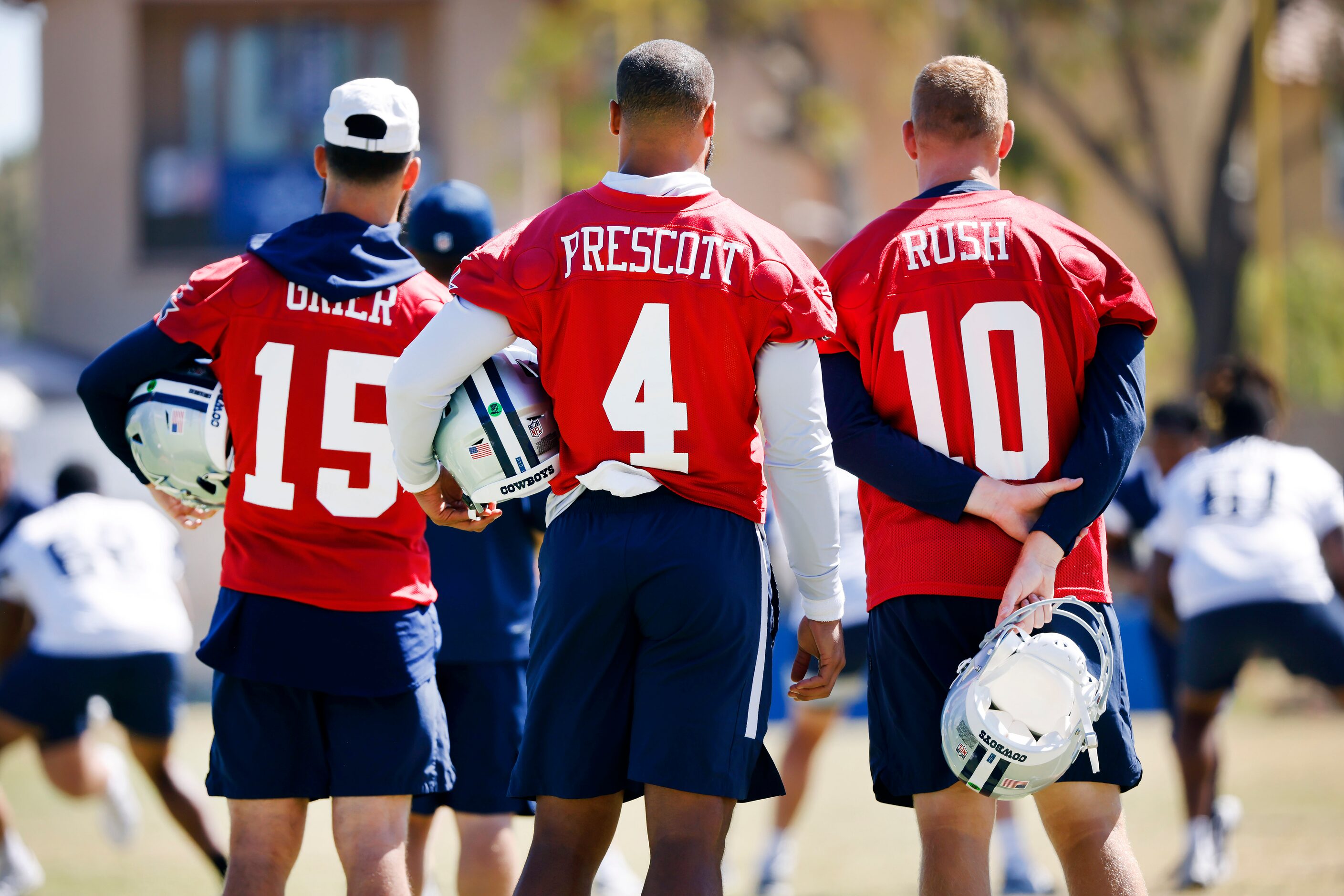 Dallas Cowboys quarterbacks Dak Prescott (4) Cooper Rush (10) and Will Grier (15) watch as...