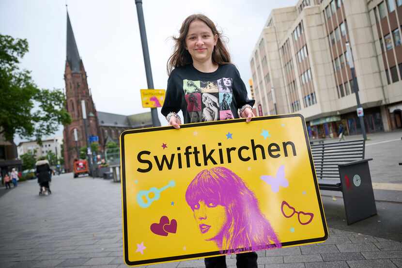 Aleshanee Westhoff shows a "Swiftkirchen" town sign in honor of musician Taylor Swift in...