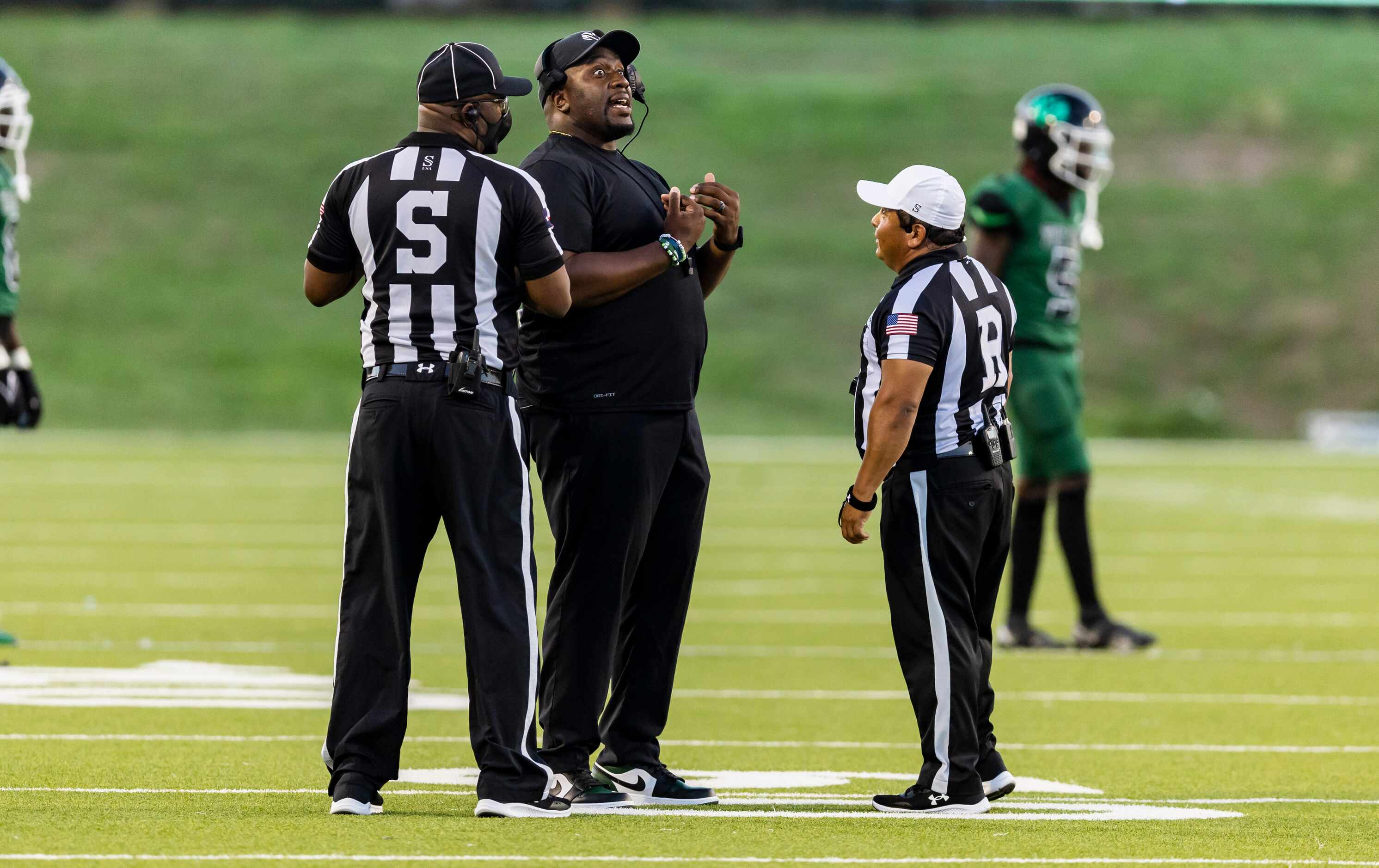 Berkner head coach Trey Bryant argues a call during the first half of a high school football...