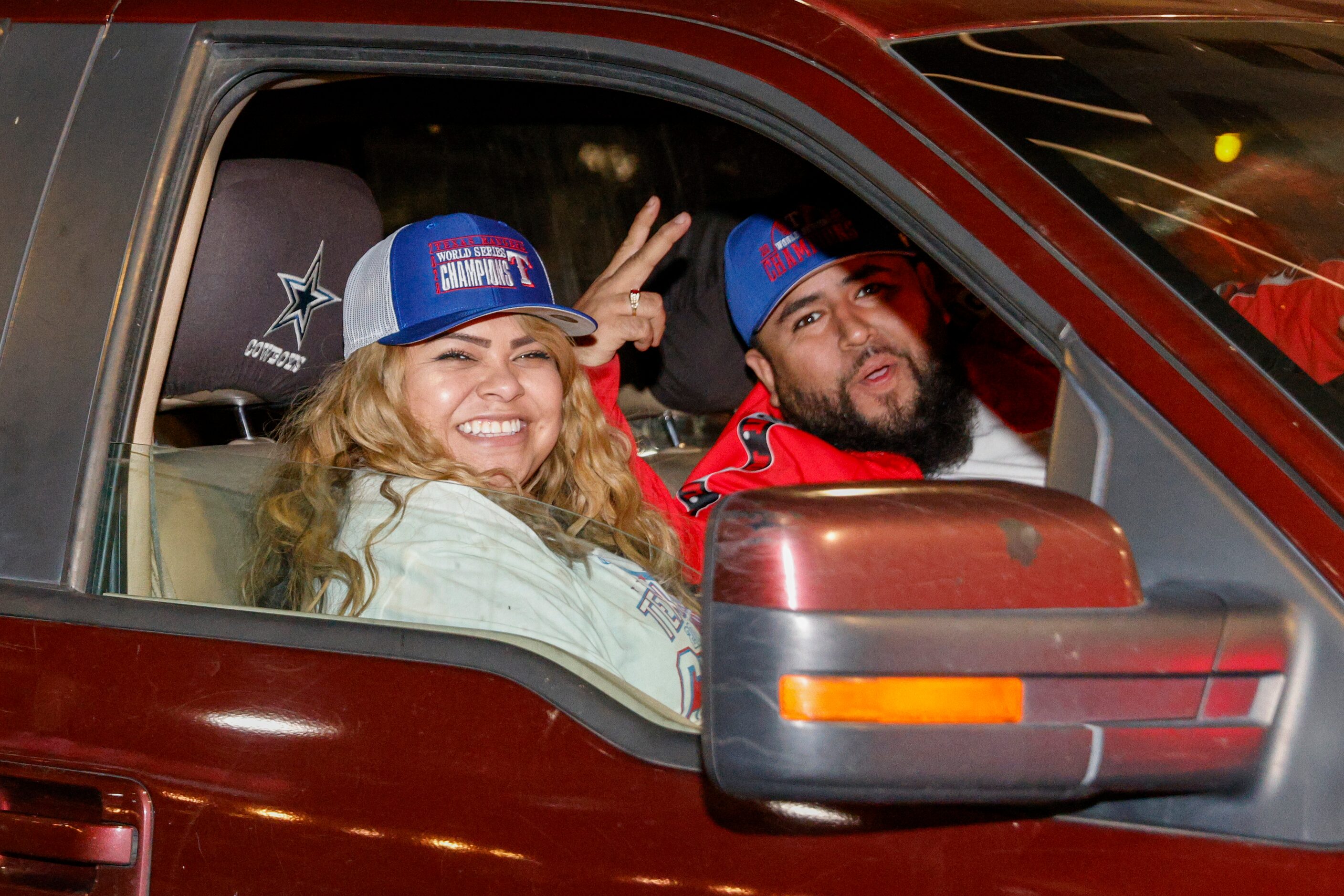 Jessica Gonzalez (left) and Robert Bravo pose for a photo with their Texas Rangers World...