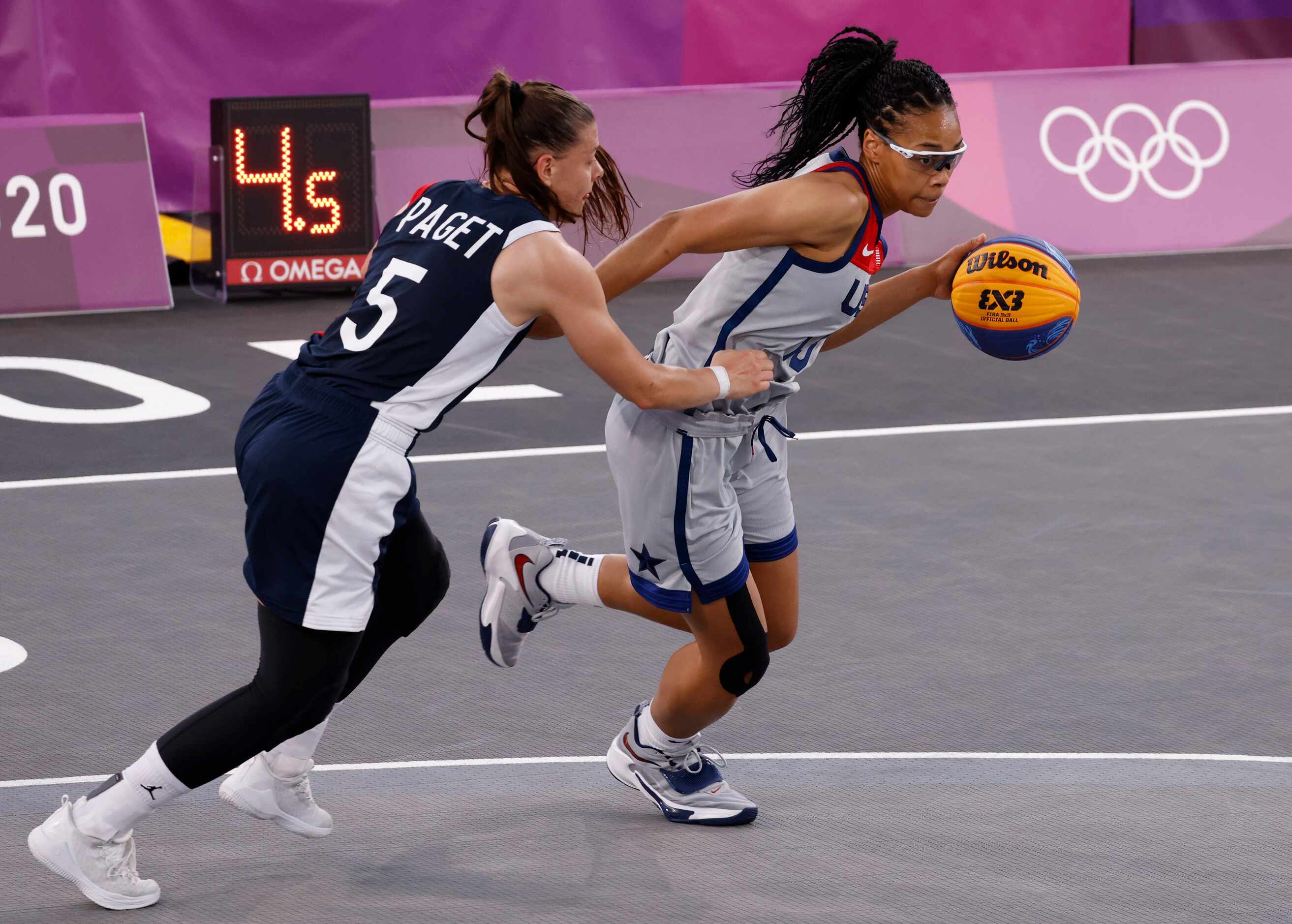 USA’s Allisha Gray (15) drives towards the basket as France’s Marie-Eve Paget (5) defends...