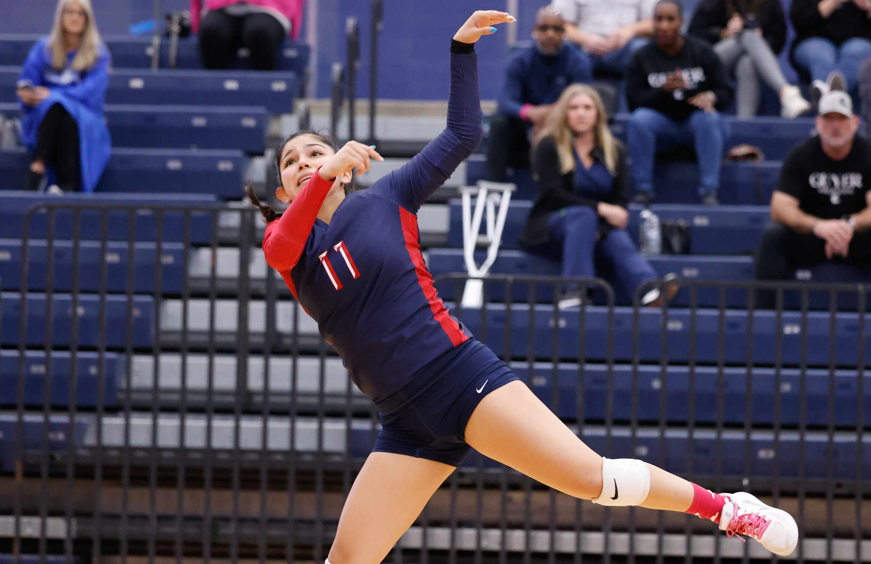 Allen senior Mia Brown (11) falls sideways after running back on the court to volley a ball...