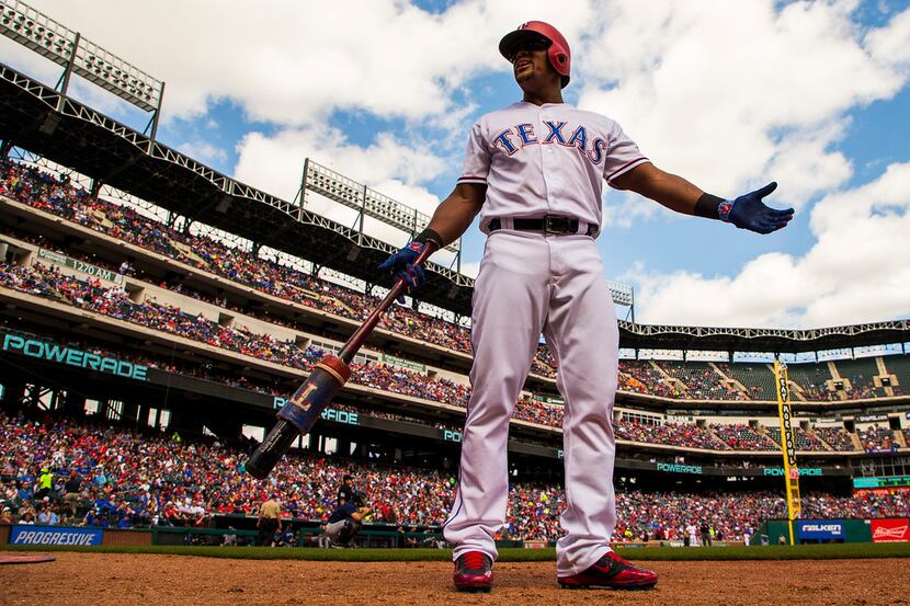 Texas Rangers third baseman Adrian Beltre motions to the crowd from the on deck circle...