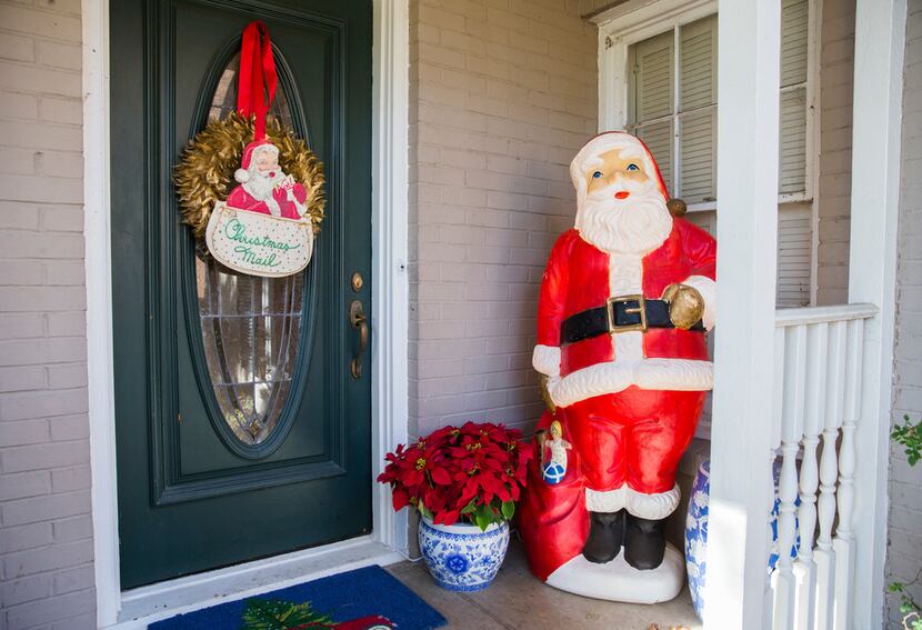 A large Santa figure is part of a collection of vintage Christmas ornaments and decorations...
