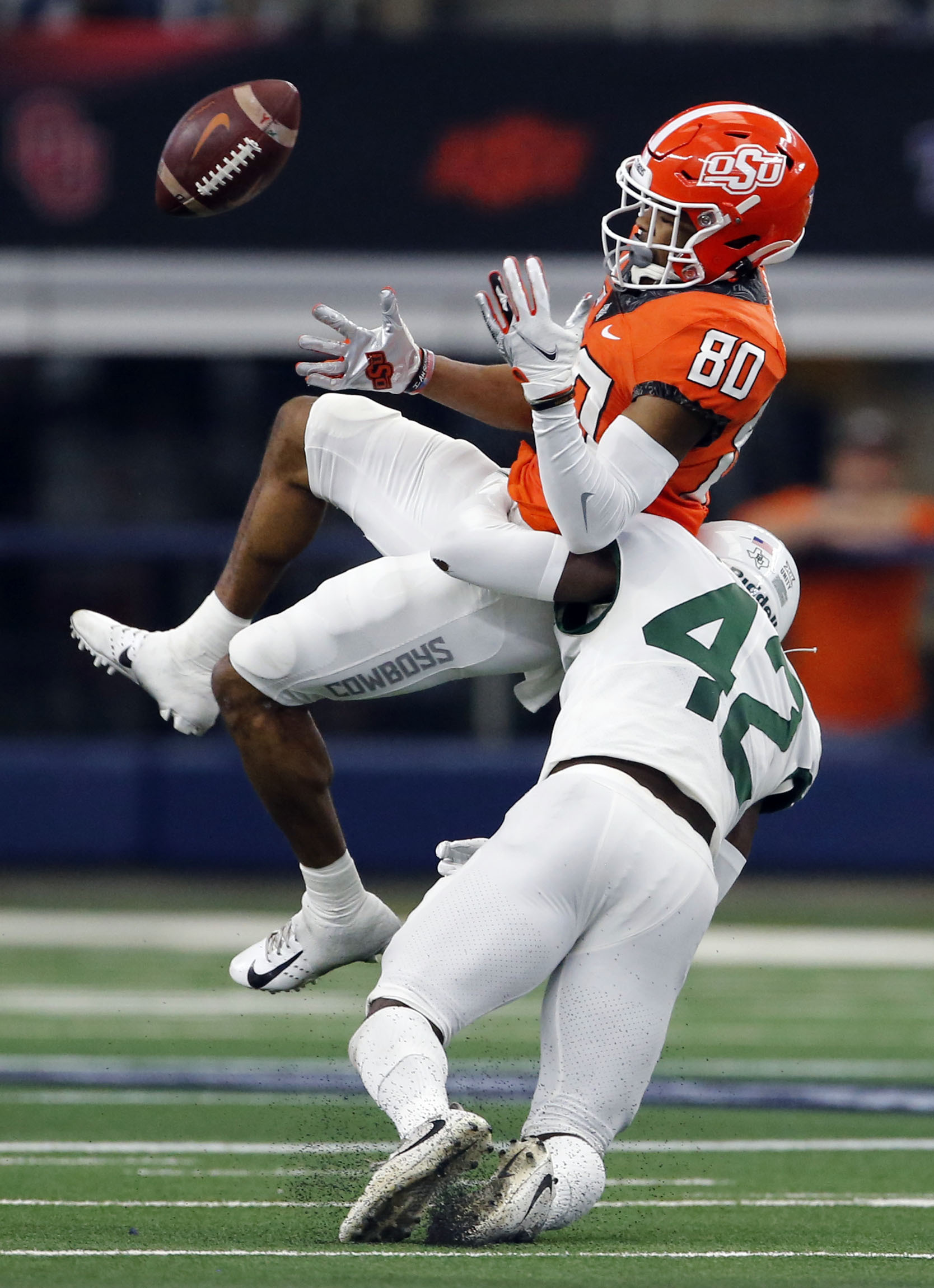 Oklahoma State Cowboys wide receiver Brennan Presley (80) loses the ball, after being hit by...