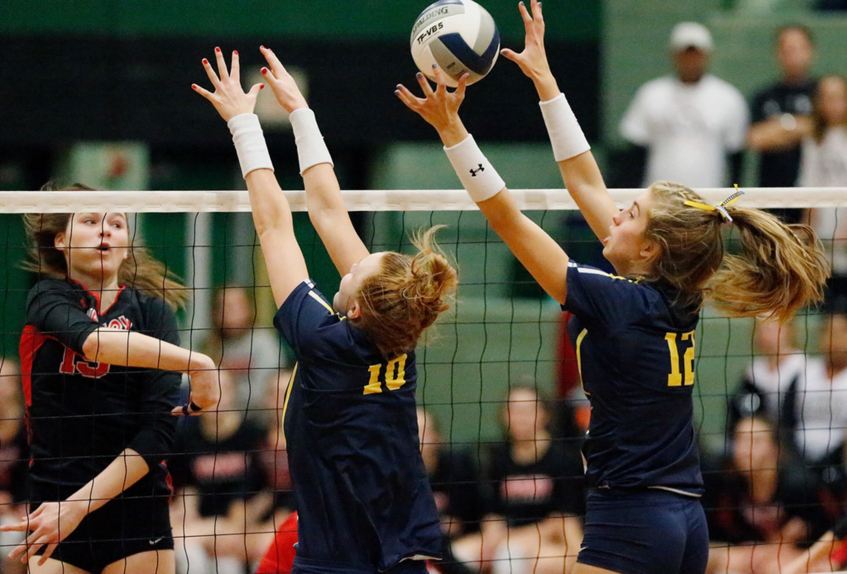 Lovejoy High School middle hitter Lexie Collins (19) attempts to hit while Highland Park...