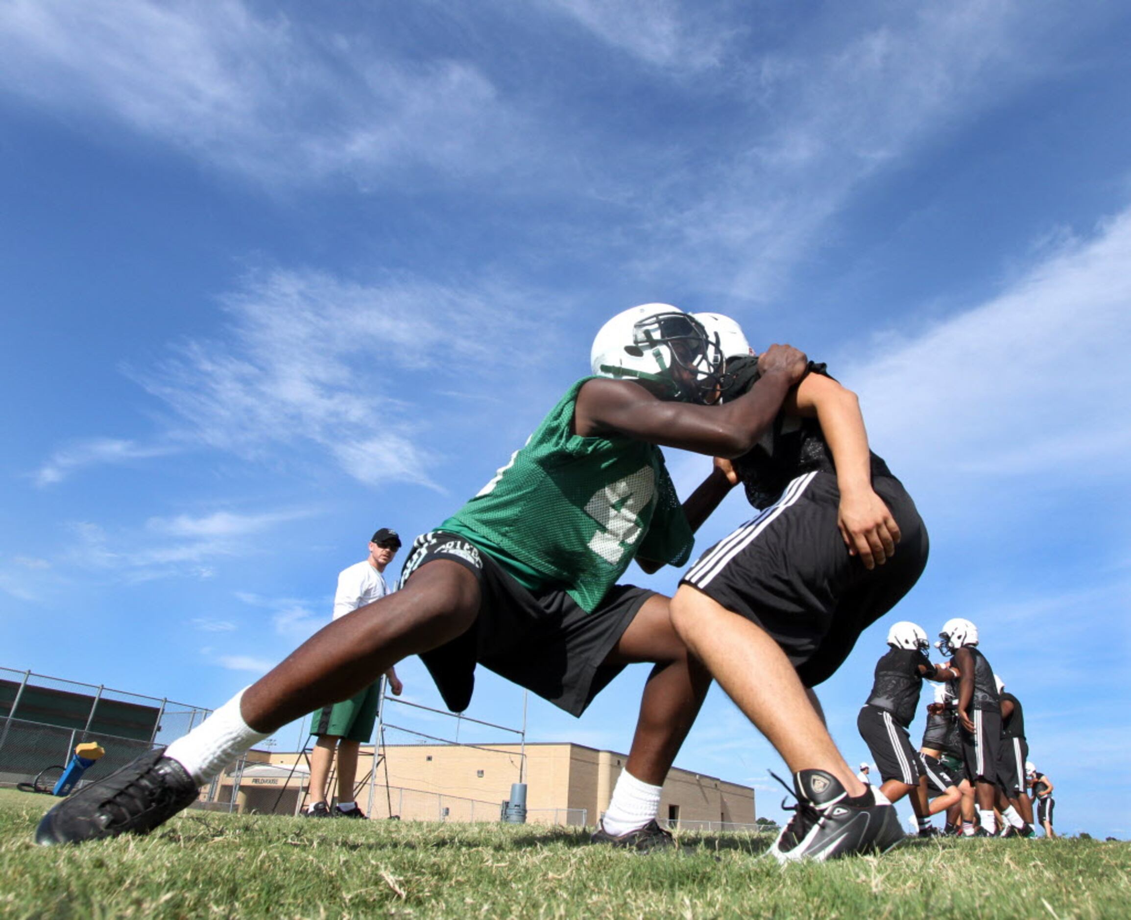 Mesquite Poteet offensive line coach Daniel Penrod watches as he directs players through...