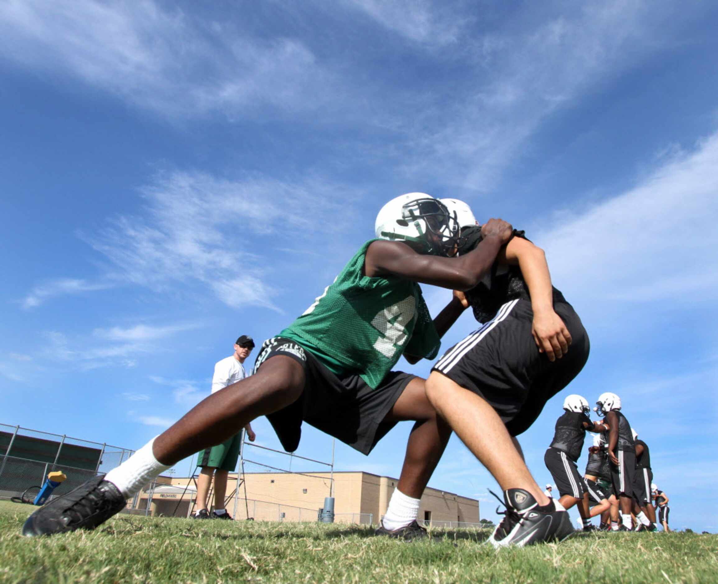 Mesquite Poteet offensive line coach Daniel Penrod watches as he directs players through...