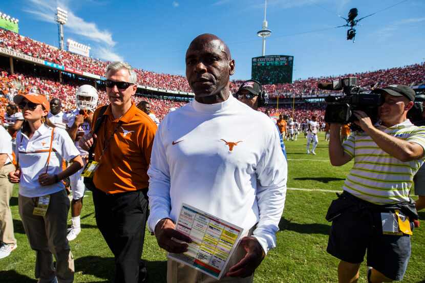 Texas Longhorns head coach Charlie Strong walks on to the field after losing the 2016 AT&T...