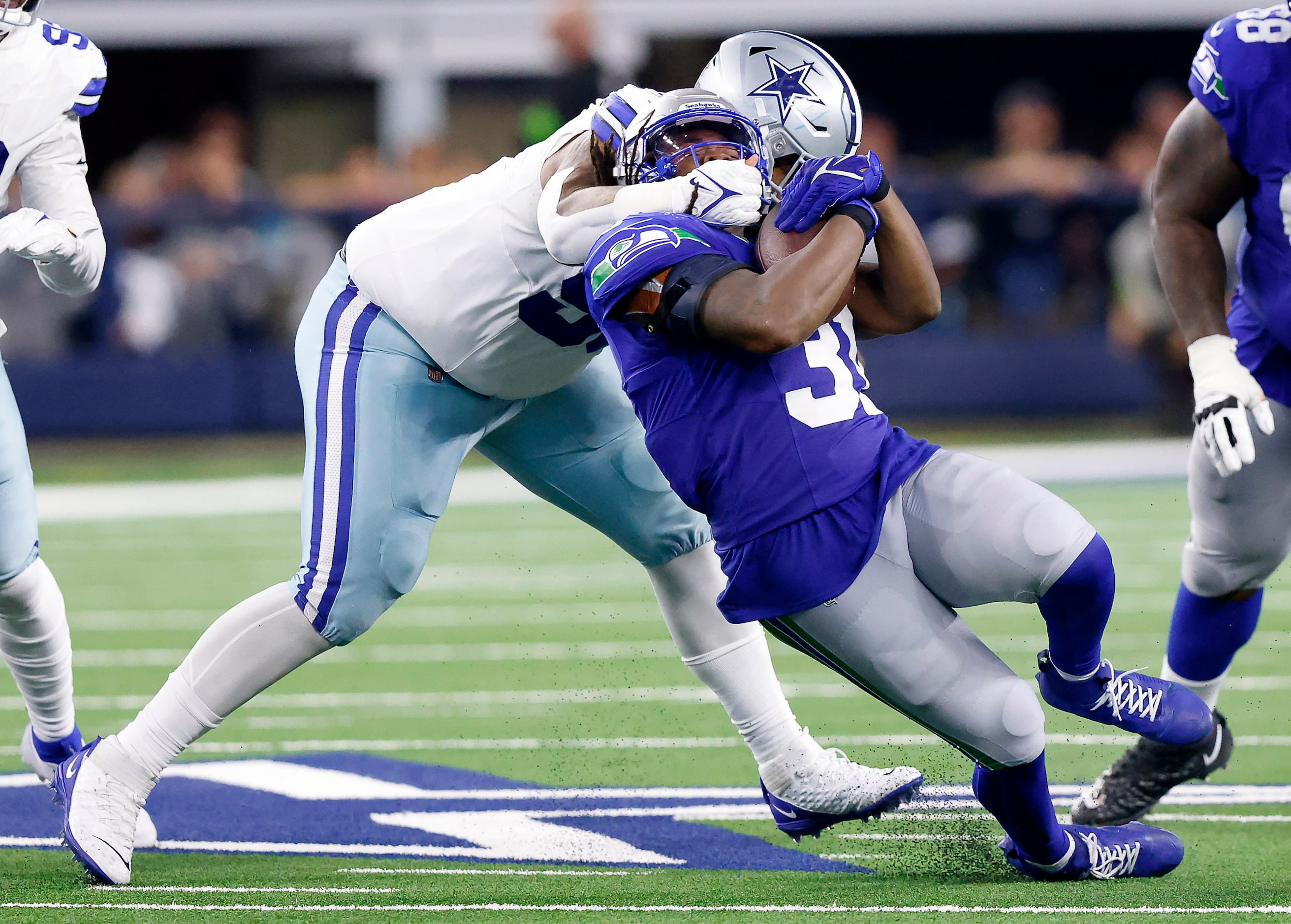 Dallas Cowboys defensive tackle Johnathan Hankins (95) tackles Seattle Seahawks running back...