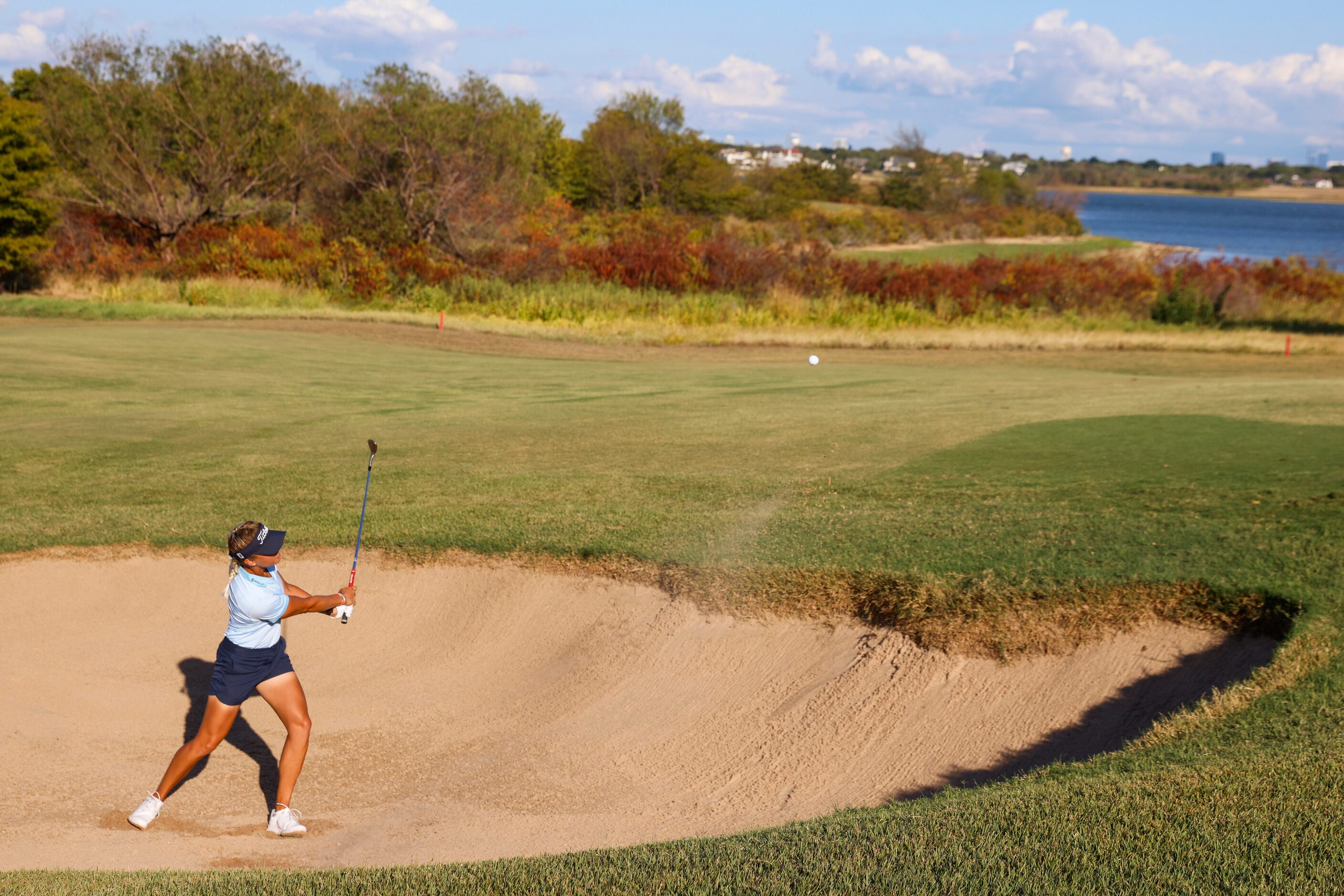 Pauline Roussin of France hits out the from a sand trap on sixth fairway during the first...