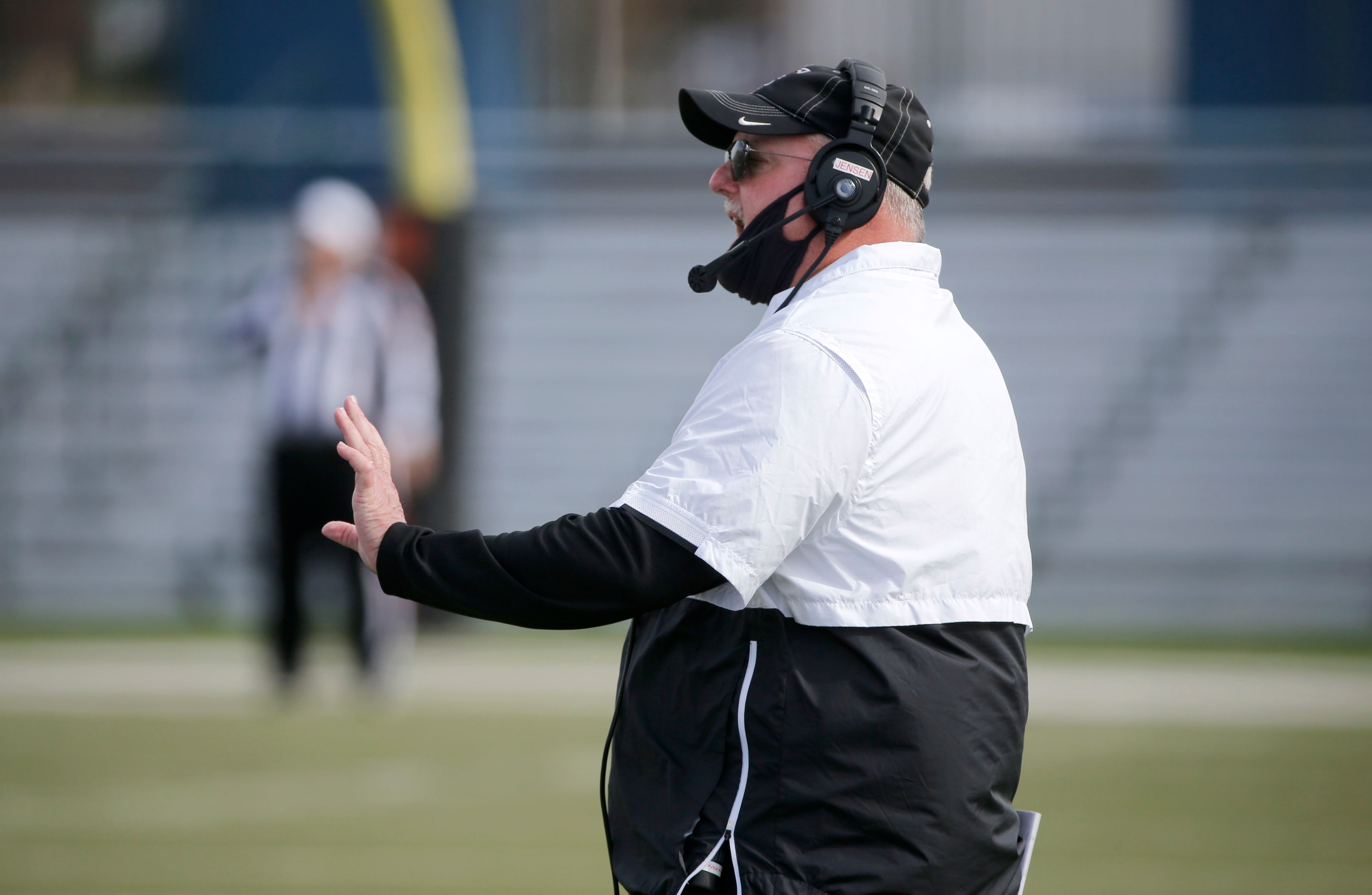 Euless Trinity coach Chris Jensen directs his team as they played Haltom during their...