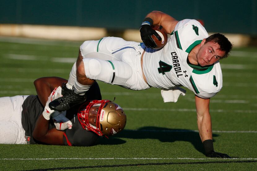 Southlake Carroll running back TJ McDaniel (4) gets tackled by South Grand Prairie...