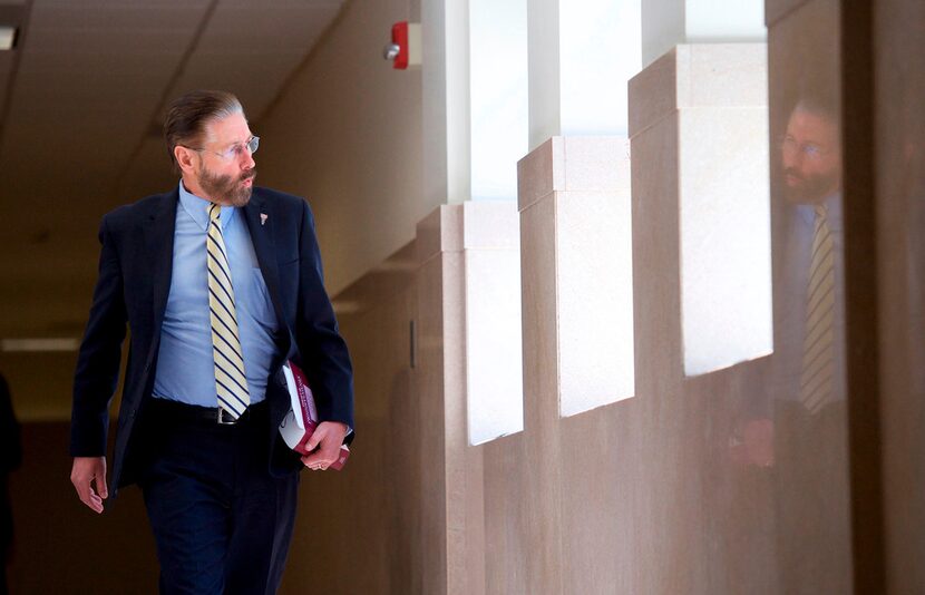 Judge Steven T. O'Neill whistles as he walks through the courthouse after learning a verdict...