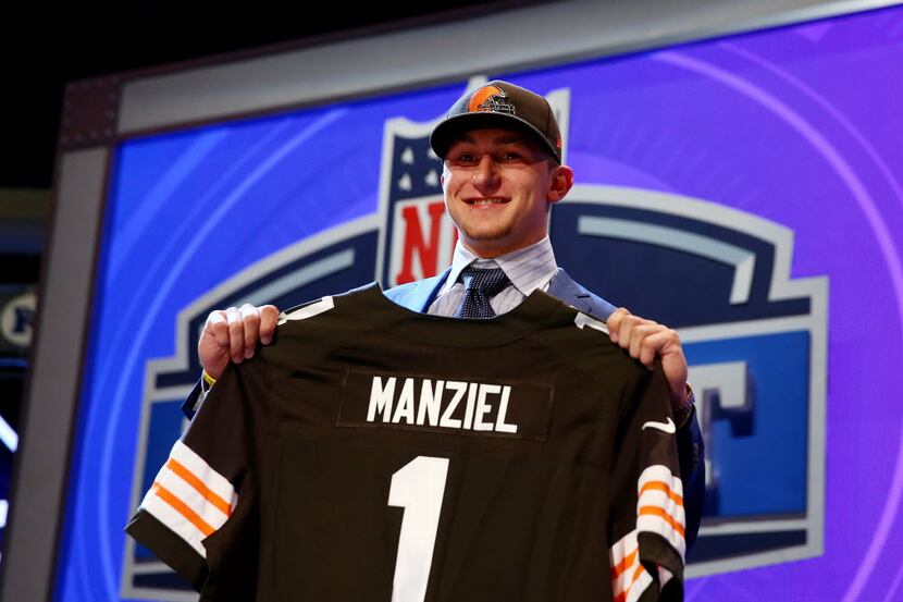 NEW YORK, NY - MAY 08:  Johnny Manziel of the Texas A&M Aggies poses with a jersey after he...