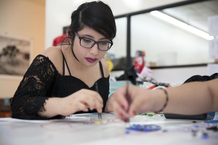
Sunset High student Leticia Pompa places mosaic tiles for the first public art project of...
