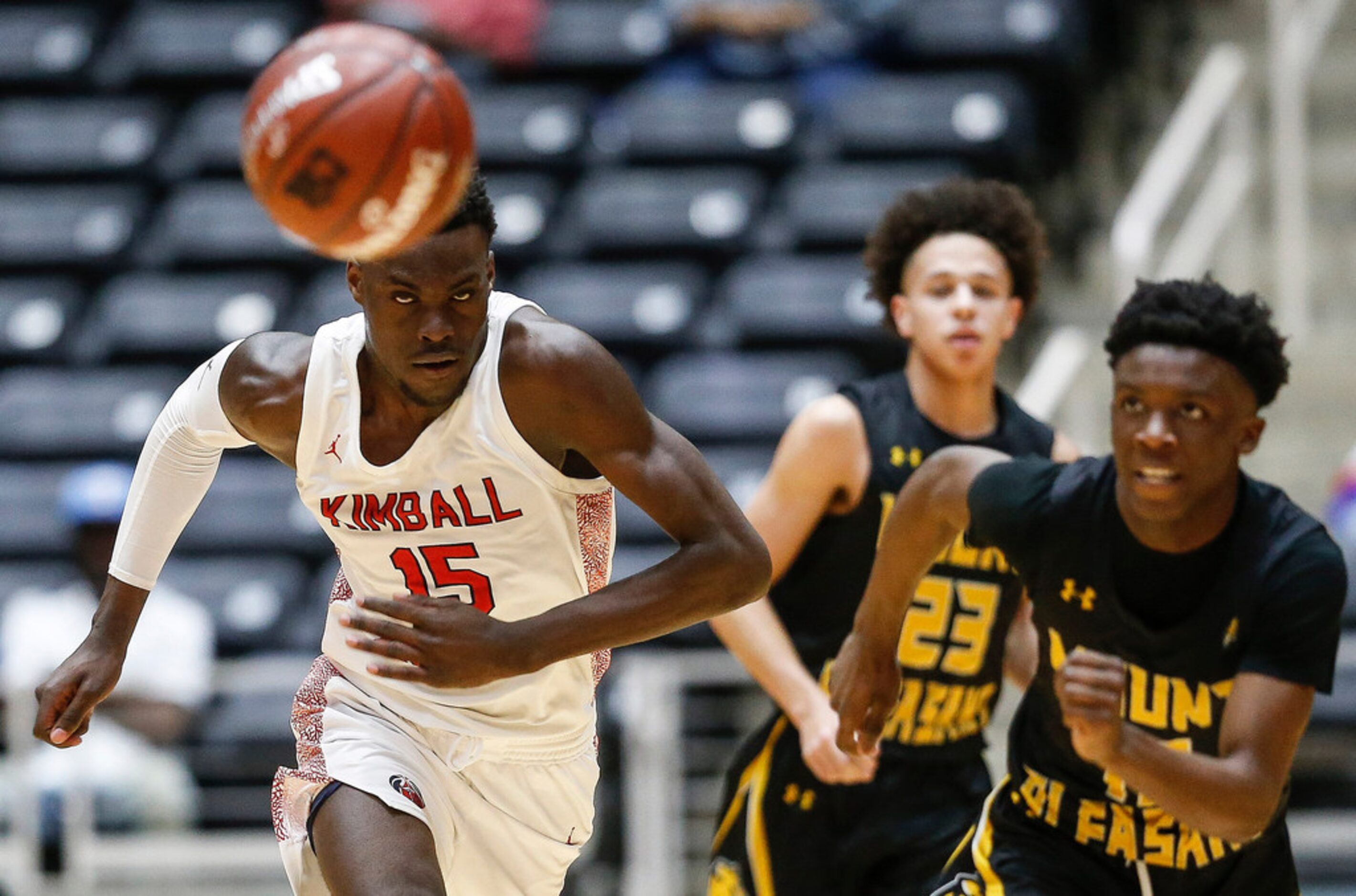 Kimball's Kyron Henderson (15) keeps his eye on a loose ball during the first half of a boys...