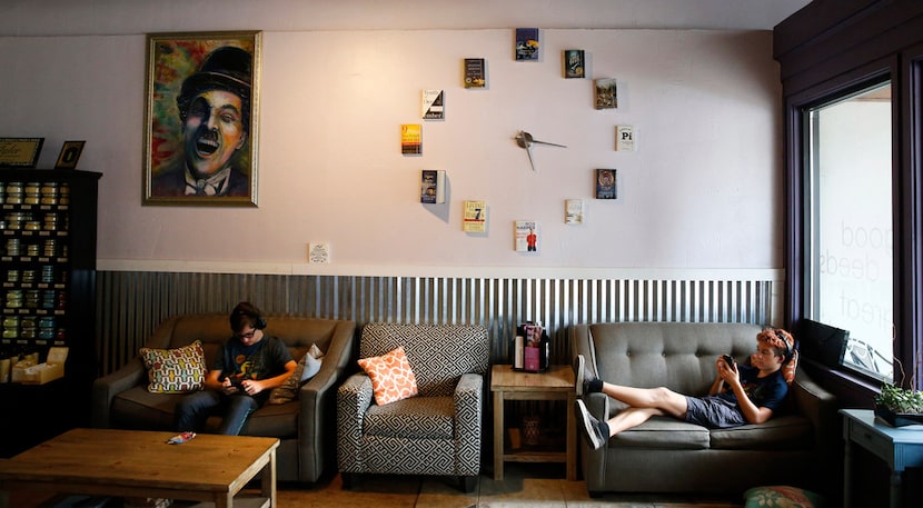 Cale Hoover, 14, (left) and Beckham Hoover, 13, play with their phones at The Bookworm Box...