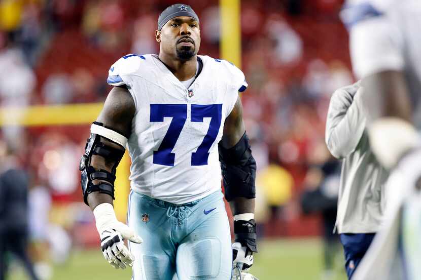 Dallas Cowboys offensive tackle Tyron Smith (77) walks off the field following their loss to...