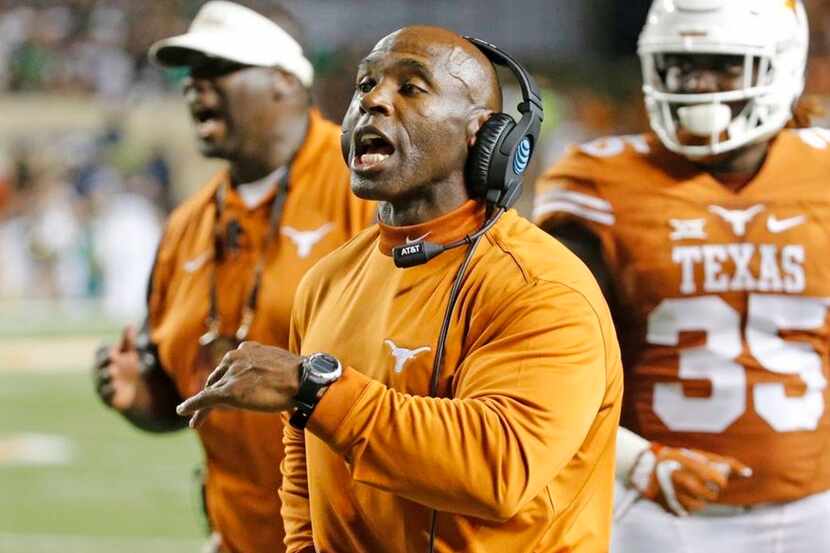 Texas coach Charlie Strong makes a point to his troops along the sidelines in the fourth...