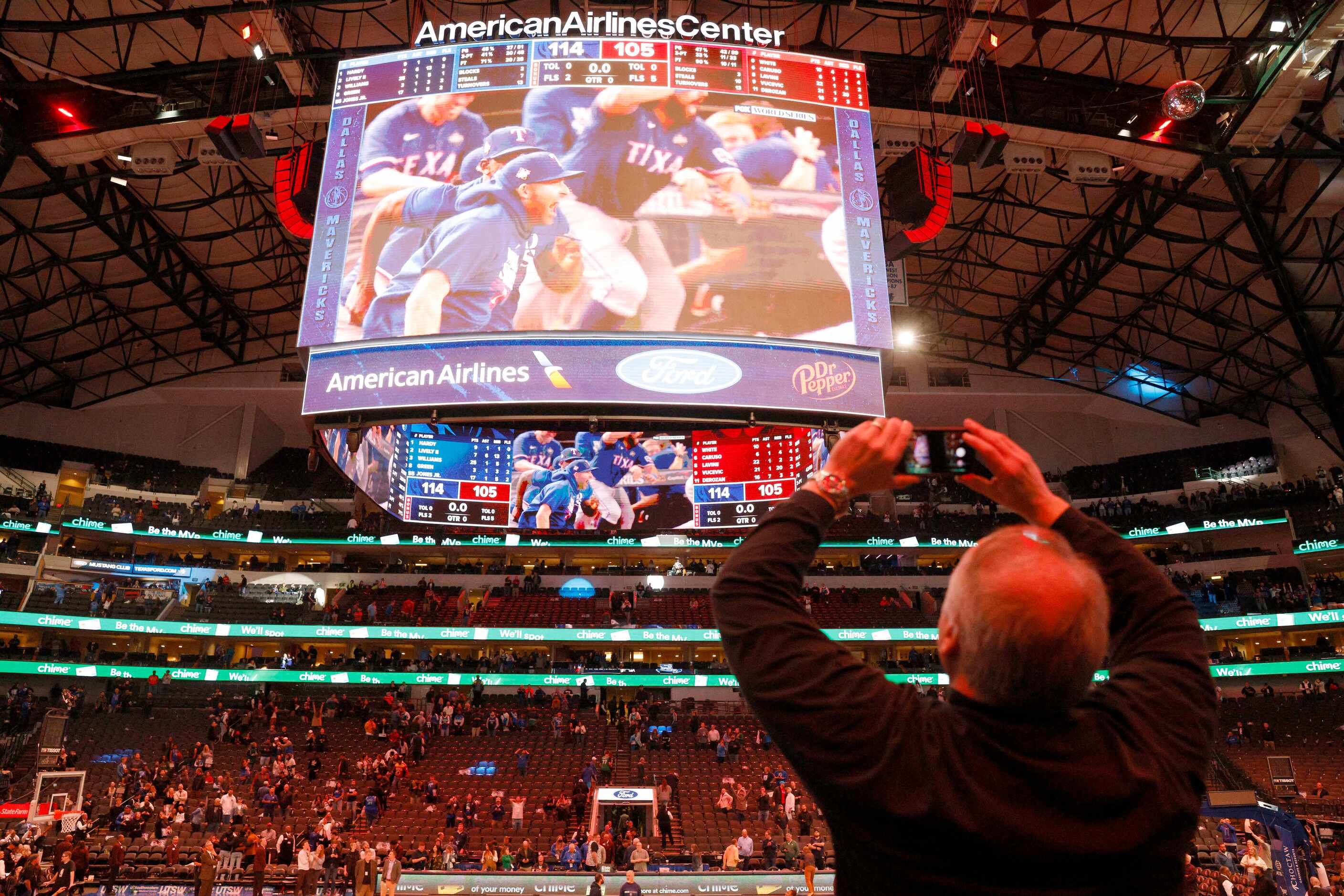A basketball fan records a video after the Texas Rangers won their first ever World Series...