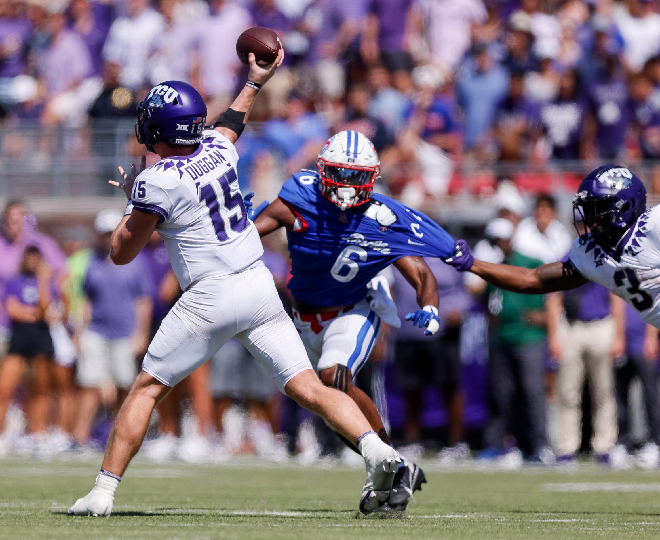 TCU quarterback Max Duggan (15) throws a pass ahead of a rushing SMU linebacker Jimmy...