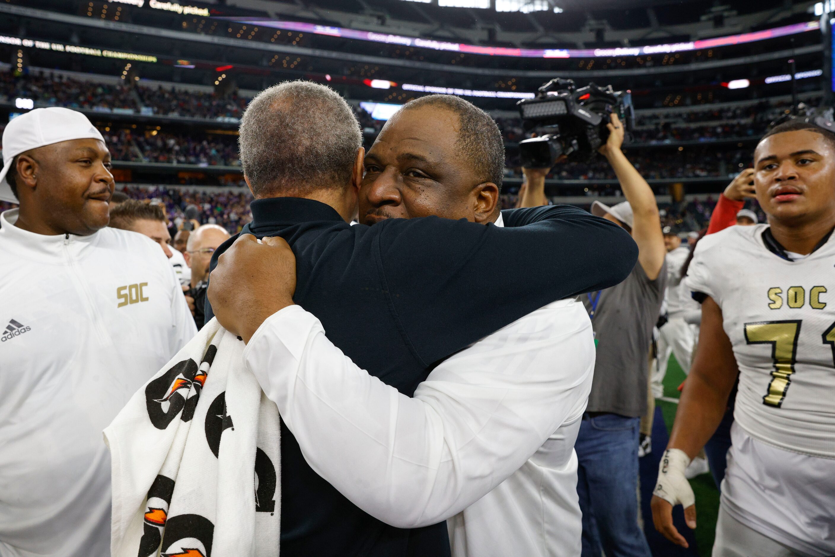 South Oak Cliff head coach Jason Todd shares an embrace after winning the Class 5A Division...