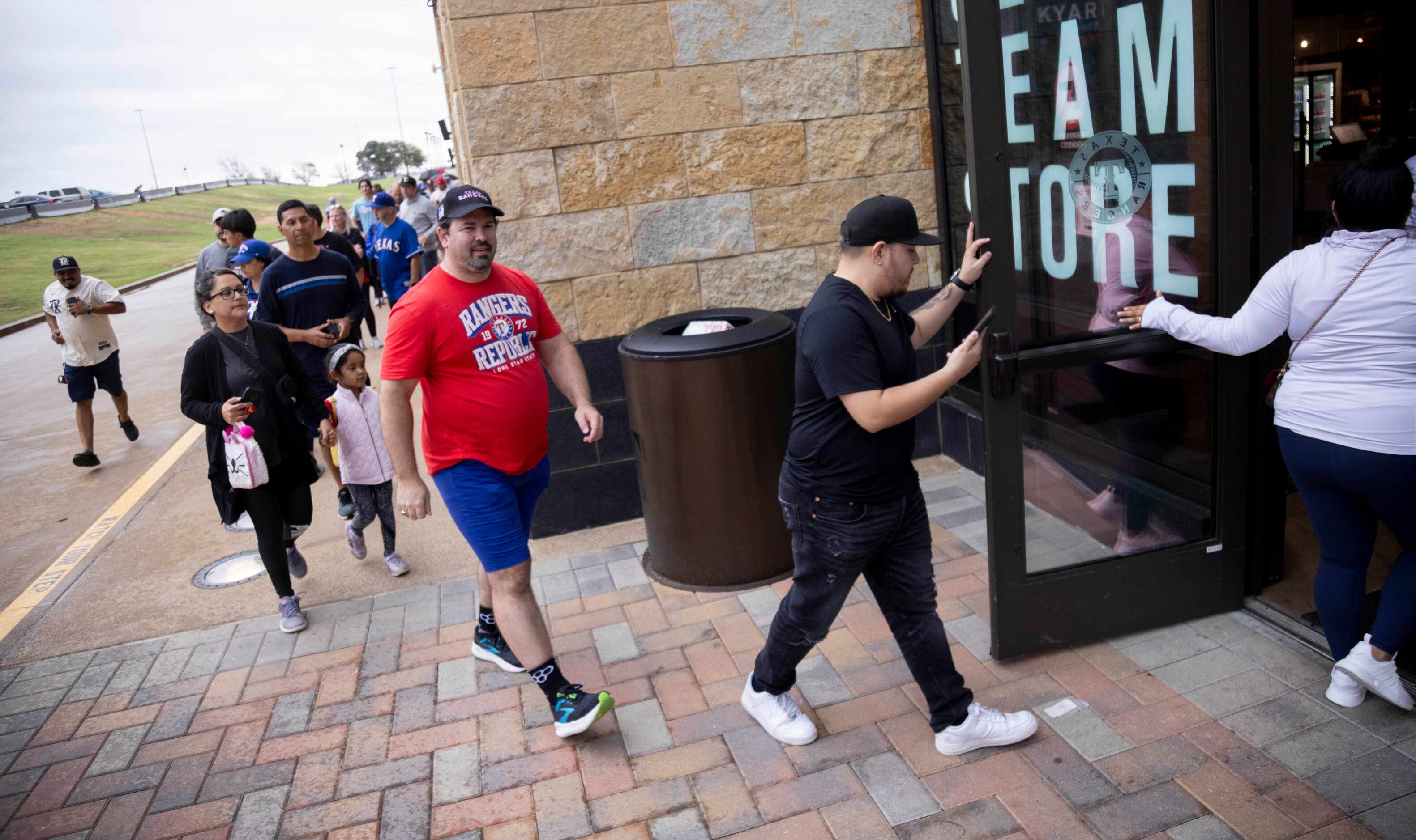 Fans enter the Grand Slam Team Store at Globe Life Field after waiting in line in Arlington...