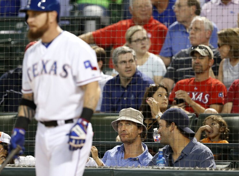 Actor Matthew McConaughey talks to Dallas Cowboys quarterback Tony Romo as Texas Rangers...