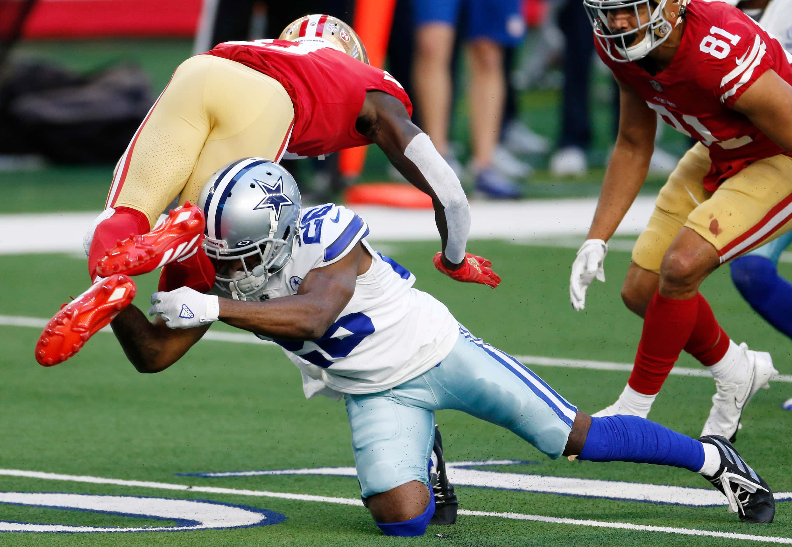 Dallas Cowboys cornerback Jourdan Lewis (26) tackles San Francisco 49ers wide receiver...