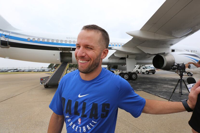 Dallas Mavericks player JJ Barea, smiles as he helps transfer supplies from a trailer to an...