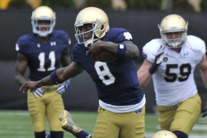 FILE - In this April 18, 2015, file photo, Notre Dame quarterback Malik Zaire (8) heads up...