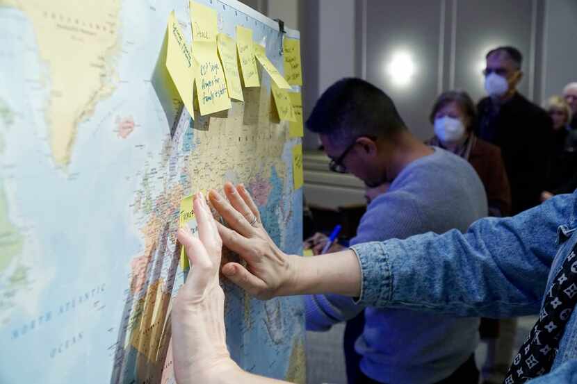 People post prayer request on a world map at the River of Life Church during a prayer...
