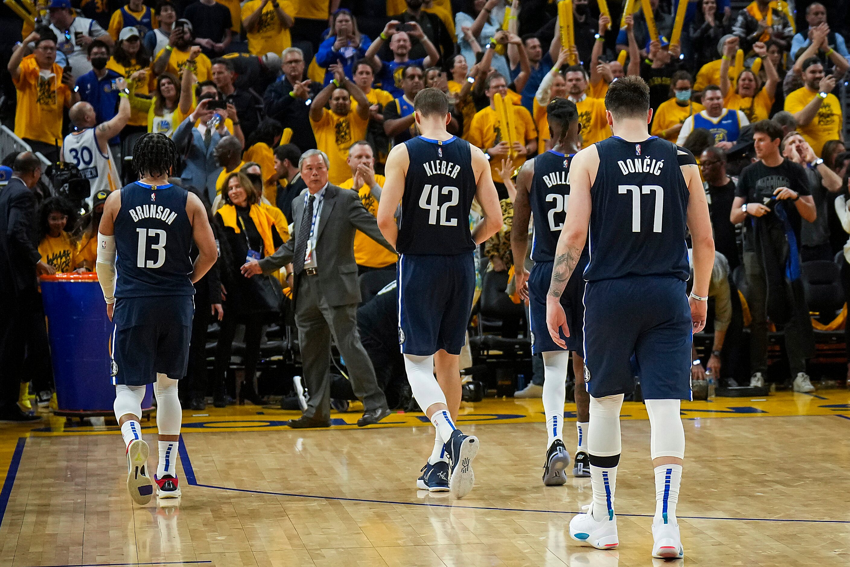 Golden State Warriors fans cheer a 126-117 victory as Dallas Mavericks guard Luka Doncic...