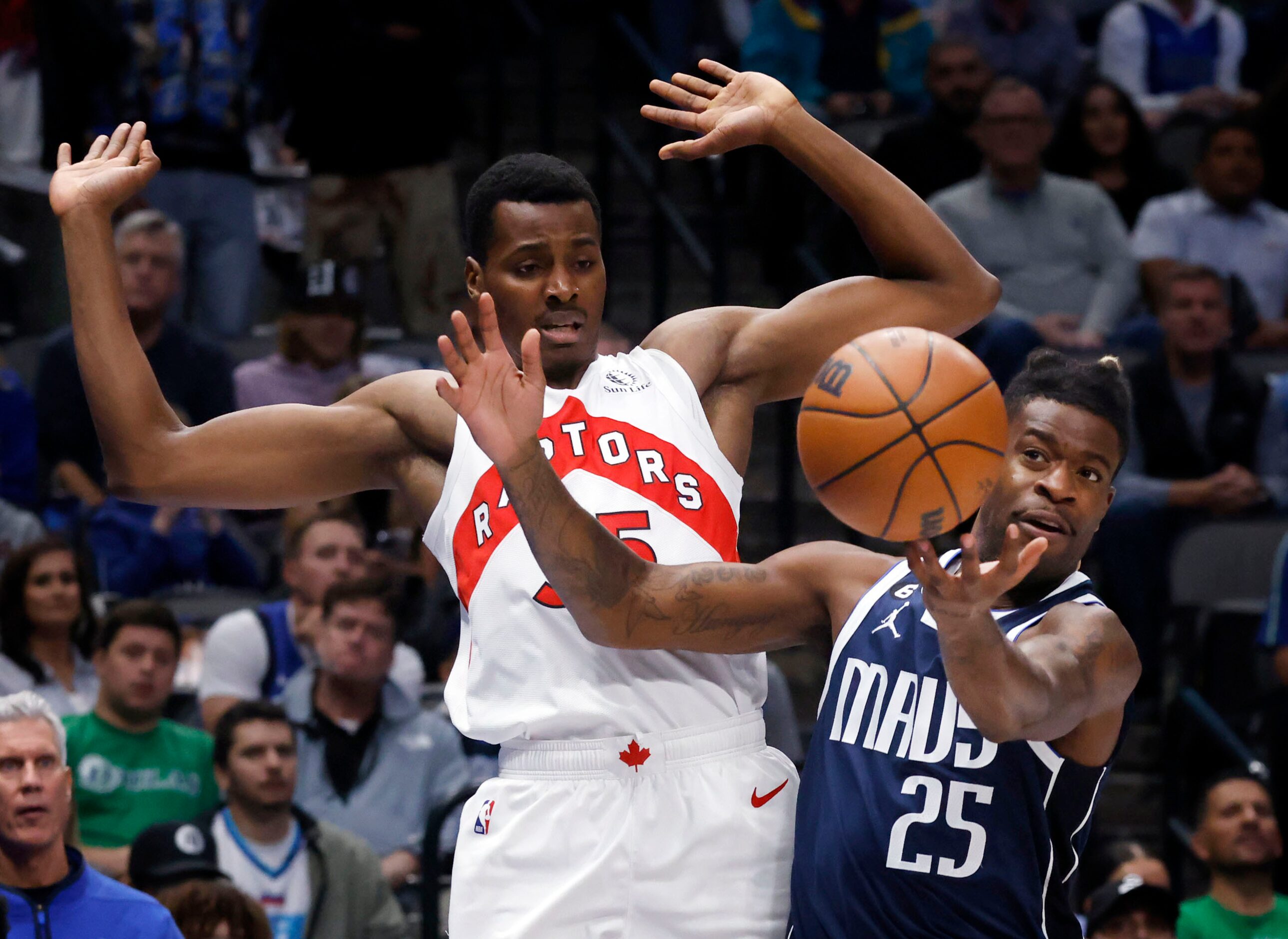 Dallas Mavericks forward Reggie Bullock (25) tries to gain control of the ball as he battled...