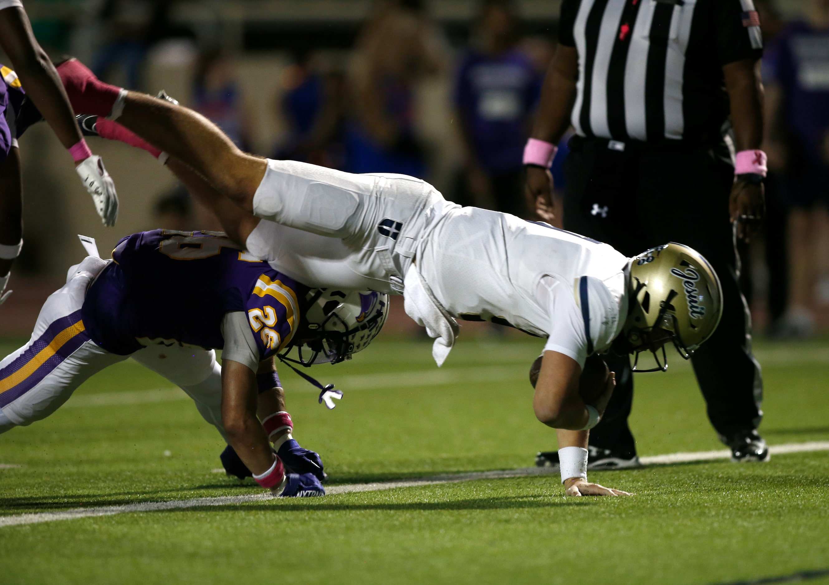 Jesuit quarterback Charlie Peters (9) dives into the end zone for a touchdown after being...