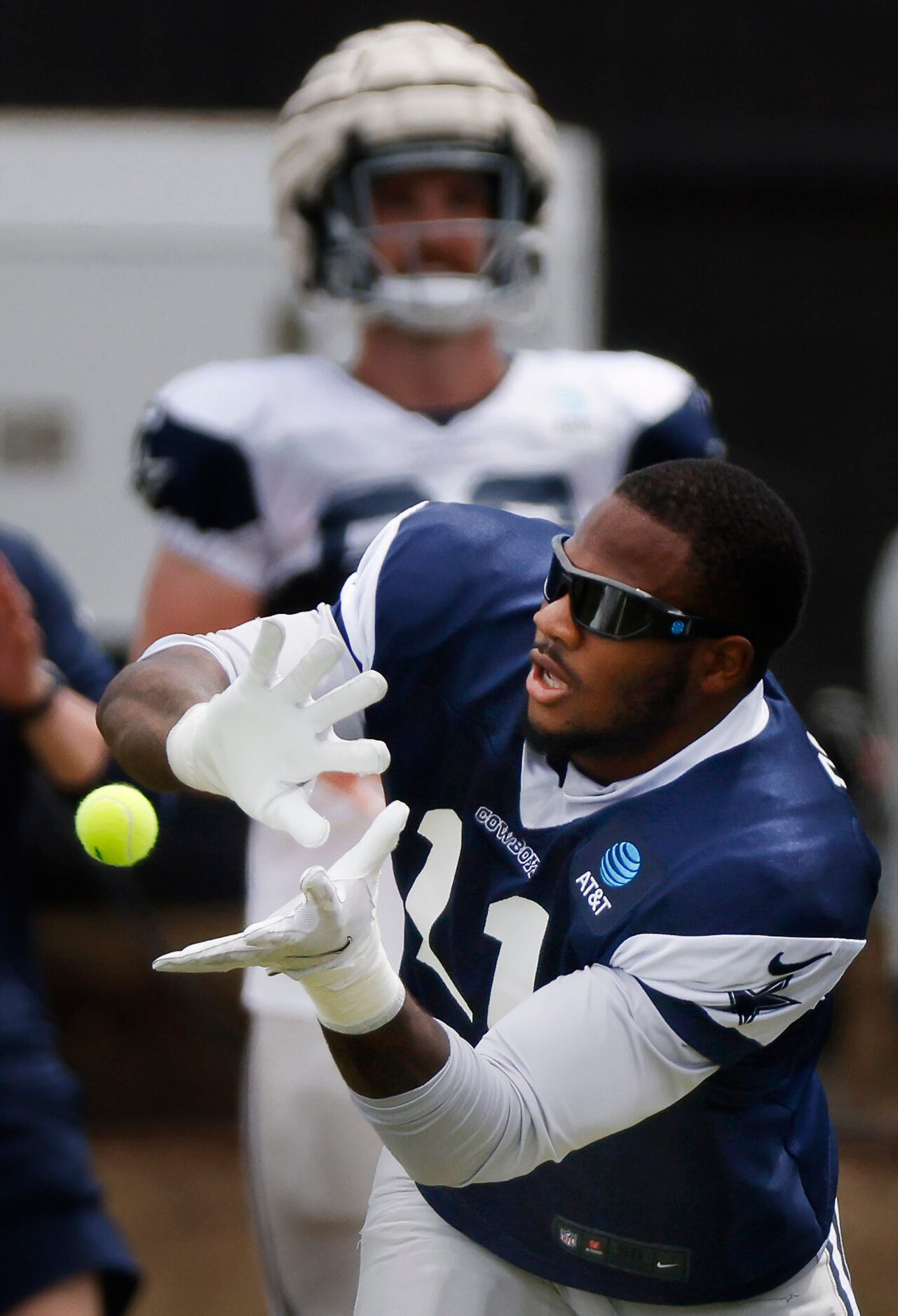 Dallas Cowboys outside linebacker Micah Parsons (11) catches tennis balls during training...