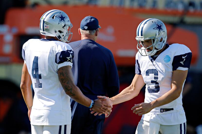 Dallas Cowboys quarterback Dak Prescott (4) high-fives quarterback Mark Sanchez during...