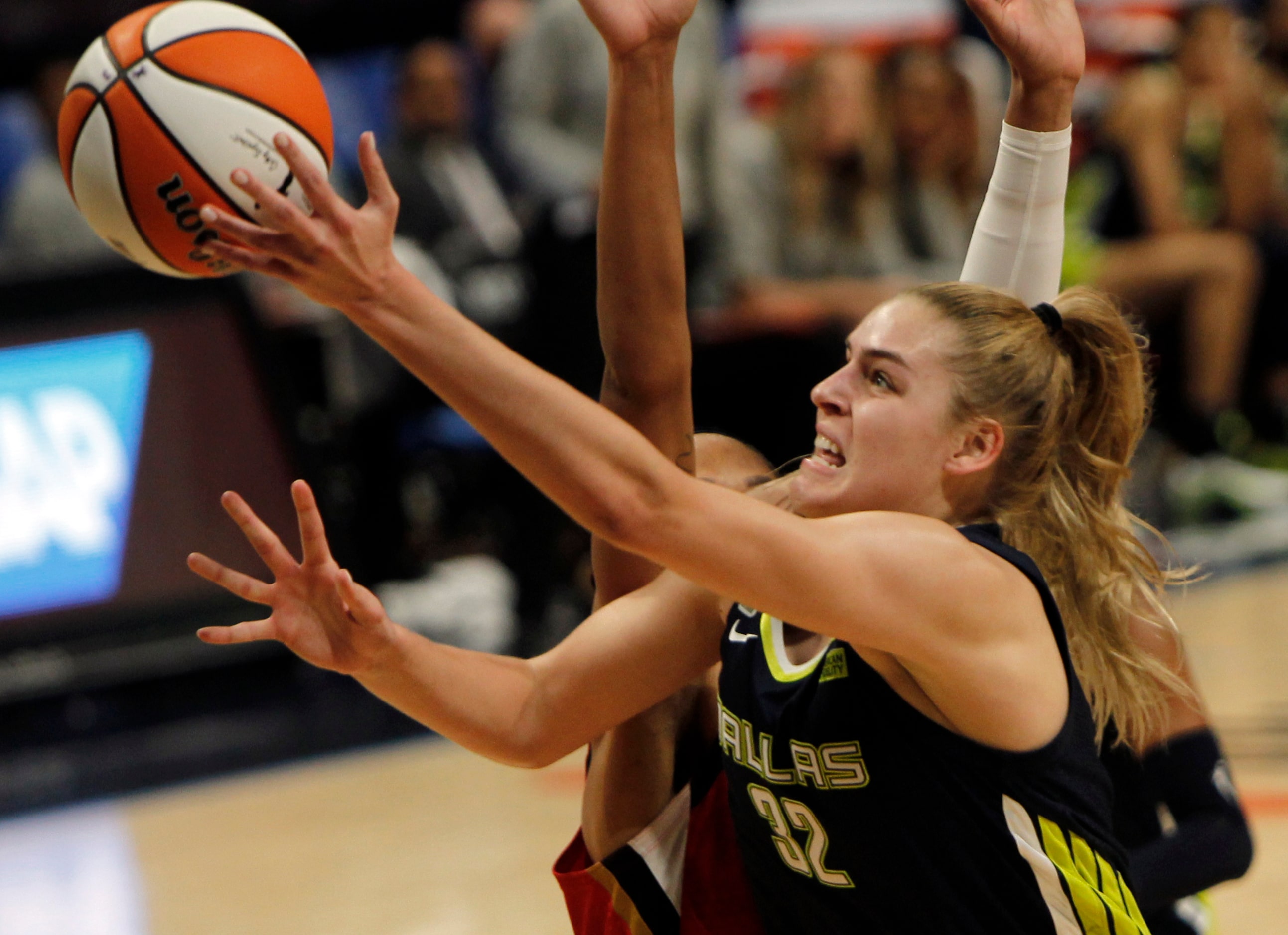 Dallas Wings center Bella Alarie (32) spins around the defense of Las Vegas forward A'ja...